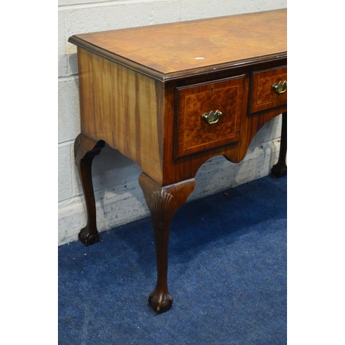 1298 - A REPRODUCTION BURR WALNUT AND BANDED DESK/DRESSING TABLE, with two deep drawers flanking a small ce... 