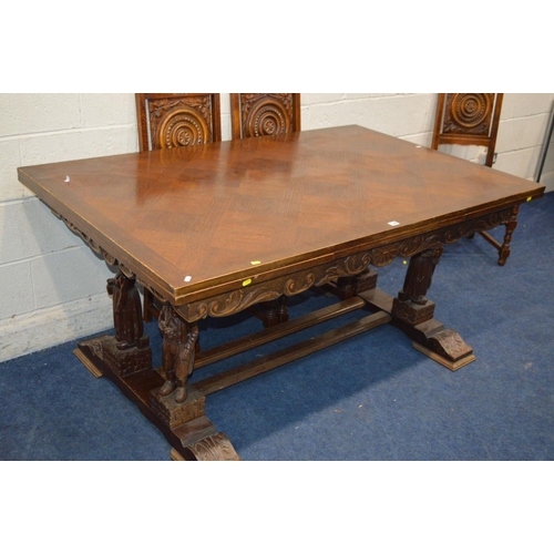 1300 - AN EARLY 20TH CENTURY OAK DRAW LEAF BRETON TABLE, raised on four standing figures united by stretche... 