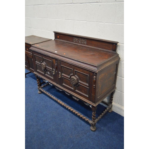 1337 - A DISTRESSED EARLY 20TH CENTURY OAK SIDEBOARD, with a raised back, double geometric panelled doors, ... 