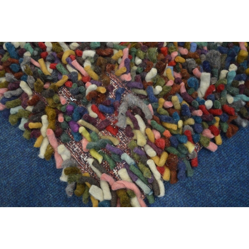 1388 - A DEEP WOOL MULTI COLOURED RUG, 192cm x 128cm (sd to one corner)