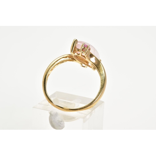 17 - A 9CT GOLD ROSE QUARTZ RING, the asymmetrical marquise rose quartz cabochon with a crossover design ... 