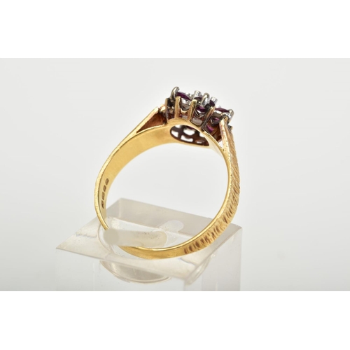 23 - AN 18CT GOLD GARNET AND DIAMOND CLUSTER RING, the tiered cluster set with a central single cut diamo... 