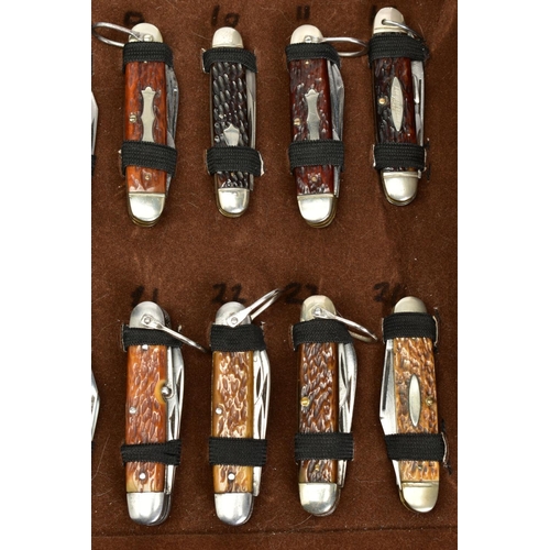 280 - A FOLD OVER CASE CONTAINING A NUMBER OF PENKNIVES, all mounted and in good condition twenty four in ... 