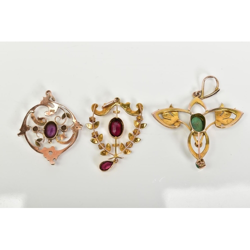 29 - A SELECTION OF THREE YELLOW METAL OPENWORK PENDANTS, to include a garnet and split pearl set pendant... 