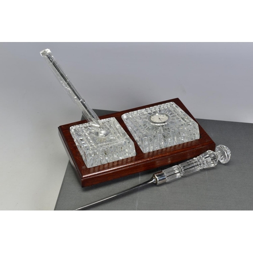 468 - A BOXED WATERFORD CRYSTAL DESK SET, comprising a quartz clock and a pen stand with pen set in a wood... 