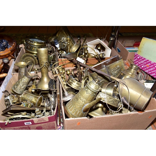 509 - FOUR BOXES OF BRASS WARES, to include candlesticks, lamp bases, trivets, jugs, bells, teapot, log ba... 