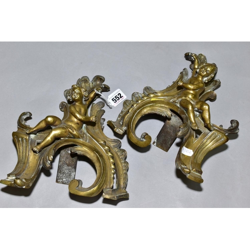 552 - A PAIR OF CAST BRASS CHERUBS ON ROCOCO SUPPORTS, possibly from a fireside fender height approximatel... 