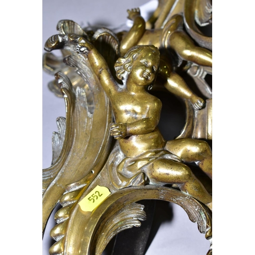 552 - A PAIR OF CAST BRASS CHERUBS ON ROCOCO SUPPORTS, possibly from a fireside fender height approximatel... 