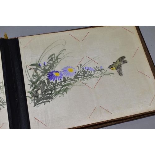 556 - A SHIBYAMA LAQUERED PHOTOGRAPH/POSTCARD ALBUM, containing 20 leaves of painted silk illustrations, t... 