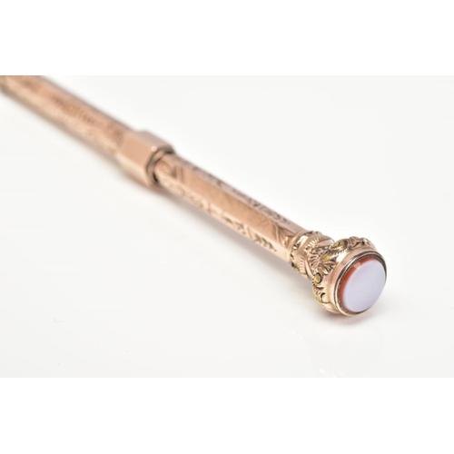 56 - A YELLOW METAL RETRACTABLE PENCIL, designed with a floral engraved pattern to the body of the pencil... 