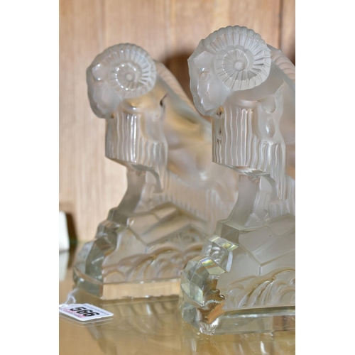 566 - A PAIR OF ART DECO FROSTED GLASS FIGURES OF RAMS, on rectangular clear glass bases, height ????, (co... 