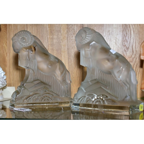 566 - A PAIR OF ART DECO FROSTED GLASS FIGURES OF RAMS, on rectangular clear glass bases, height ????, (co... 