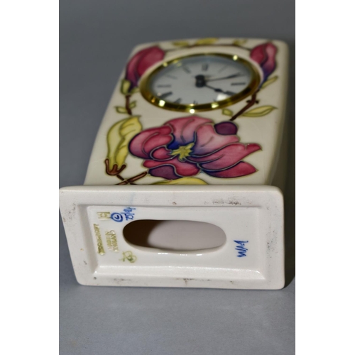 574 - A MOORCROFT POTTERY QUARTZ MANTEL CLOCK, pink magnolia design on a cream ground, impressed and paint... 