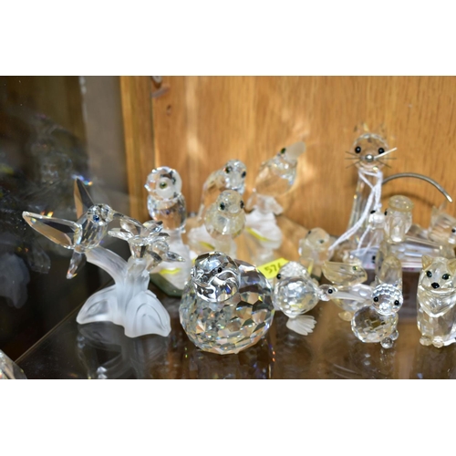 576 - A COLLECTION OF SWAROVSKI CRYSTAL DOG, CAR AND BIRD FIGURES, with a mirrored stand, including Owl, K... 