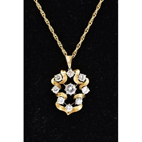 71 - A YELLOW METAL DIAMOND PENDANT NECKLACE, the yellow metal openwork scroll detail pendant set with ni... 