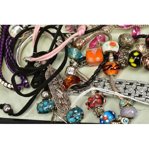 74 - A SELECTION OF COSTUME JEWELLERY, to include two white metal charm bracelets with charms, a pink cor... 