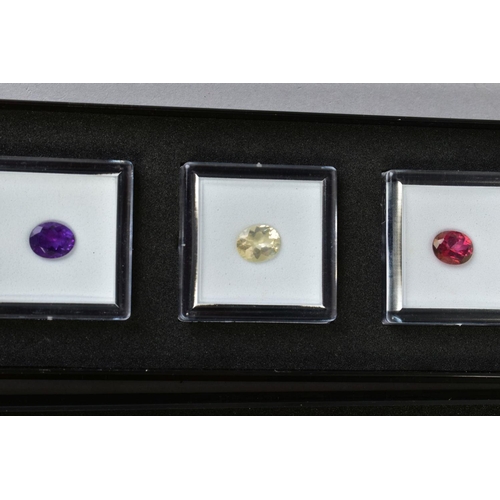 84 - A SMALL SELECTION OF GEMSTONES, to include a box of three oval cut stones assessed as amethyst, citr... 