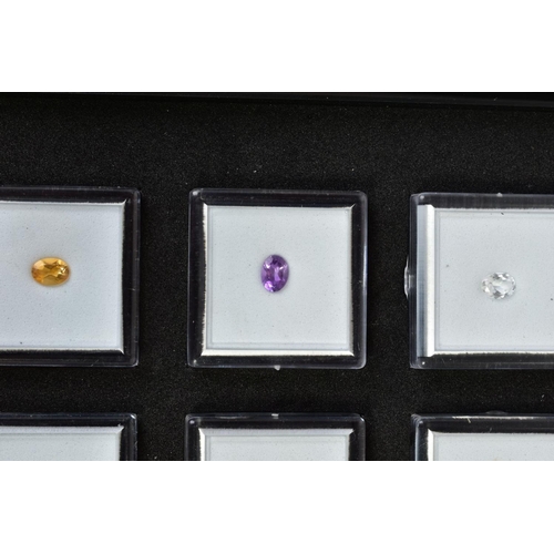 84 - A SMALL SELECTION OF GEMSTONES, to include a box of three oval cut stones assessed as amethyst, citr... 