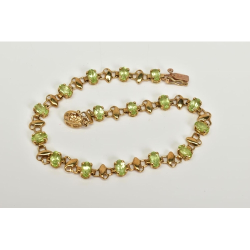 3 - A 9CT GOLD PERIDOT LINE BRACELET, set with sixteen claw set oval cut peridots each interspaced with ... 