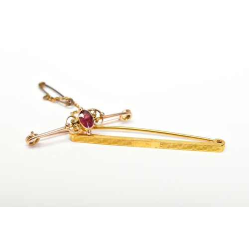 30 - TWO YELLOW METAL BROOCHES, to include a bar brooch set with an oval cut garnet within a collet mount... 