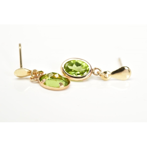 4 - A PAIR OF PERIDOT DROP EARRINGS, each designed with an oval cut peridot within a collet mount suspen... 