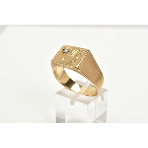 38 - A GENTLEMANS 9CT GOLD SIGNET RING, designed with a square with engraved initial, set with a single r... 