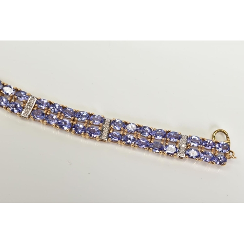 42 - AN AMETHYST AND DIAMOND BRACELET, designed with eight panels with two rows of oval cut amethyst, int... 