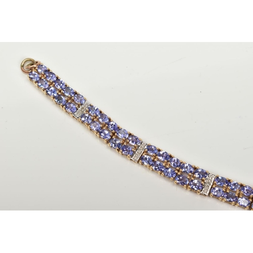 42 - AN AMETHYST AND DIAMOND BRACELET, designed with eight panels with two rows of oval cut amethyst, int... 