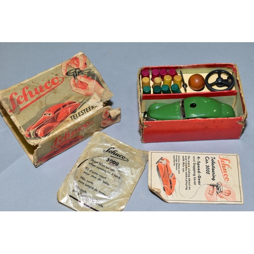 438 - A BOX OF VINTAGE TOYS AND DOLLS INCLUDING A BOXED GREEN SCHUCO TELESTEERING CAR 3000, three wheels o... 