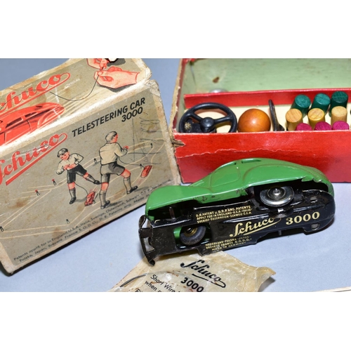 438 - A BOX OF VINTAGE TOYS AND DOLLS INCLUDING A BOXED GREEN SCHUCO TELESTEERING CAR 3000, three wheels o... 