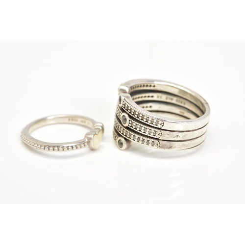 97 - TWO WHITE METAL RINGS, the first of open work design with multiple rows set with colourless and blue... 