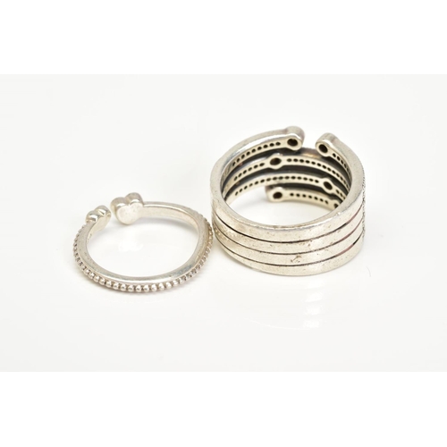 97 - TWO WHITE METAL RINGS, the first of open work design with multiple rows set with colourless and blue... 