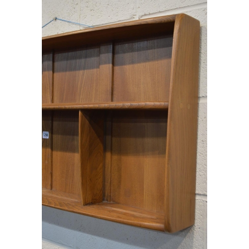 1298 - AN ERCOL GOLDEN DAWN ELM HANGING PLATE RACK, width 107cm x depth 12cm x height 50cm