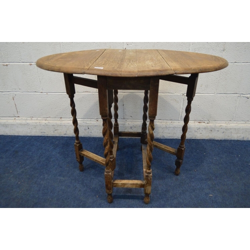 1300 - A SMALL EARLY 20TH CENTURY OAK OVAL TOPPED BARLEY TWIST GATE LEG TABLE
