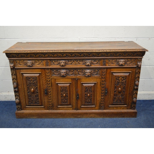 1334 - AN EARLY 20TH CENTURY CARVED OAK SIDEBOARD, foliate and lunette decoration, four drawers with lion h... 