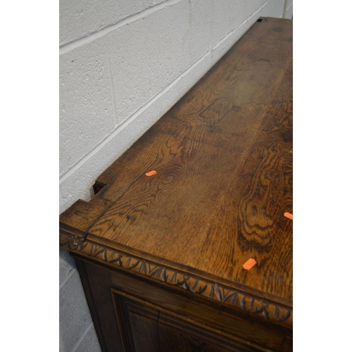 1334 - AN EARLY 20TH CENTURY CARVED OAK SIDEBOARD, foliate and lunette decoration, four drawers with lion h... 