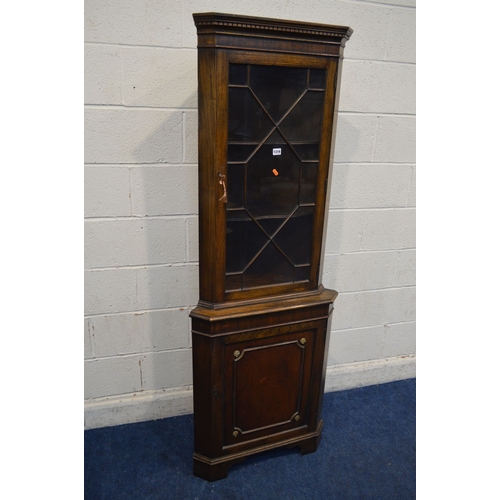 1319 - A REPRODUCTION MAHOGANY GLAZED SINGLE DOOR CORNER CUPBOARD (key) together with a modern grey foliate... 