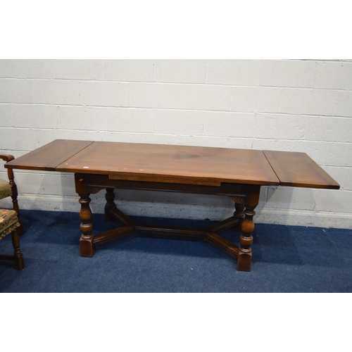 1328 - A REPRODUCTION OAK DRAW LEAF DINING TABLE, on block and turned legs, united by a cross stretcher, ex... 