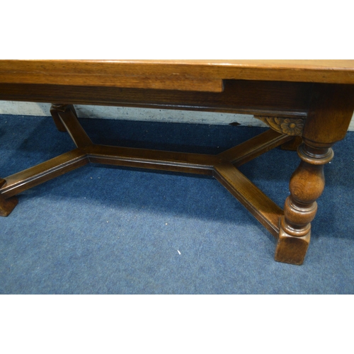 1328 - A REPRODUCTION OAK DRAW LEAF DINING TABLE, on block and turned legs, united by a cross stretcher, ex... 