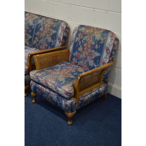 1346 - AN EARLY TO MID 20TH CENTURY MAHOGANY THREE PIECE BERGERE LOUNGE SUITE, with floral blue upholstery,... 