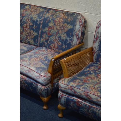 1346 - AN EARLY TO MID 20TH CENTURY MAHOGANY THREE PIECE BERGERE LOUNGE SUITE, with floral blue upholstery,... 