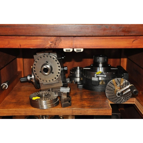 125 - A WOODEN CABINET CONTAINING, Milling machine and Lathe parts including Rotary tables, dividing Heads... 