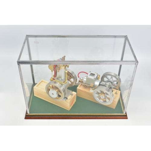 27 - TWO UNMARKED SINGLE CYLINDER ENGINES CONTAINED IN A GLASS AND WOODEN DISPLAY CASE, not tested, petro... 