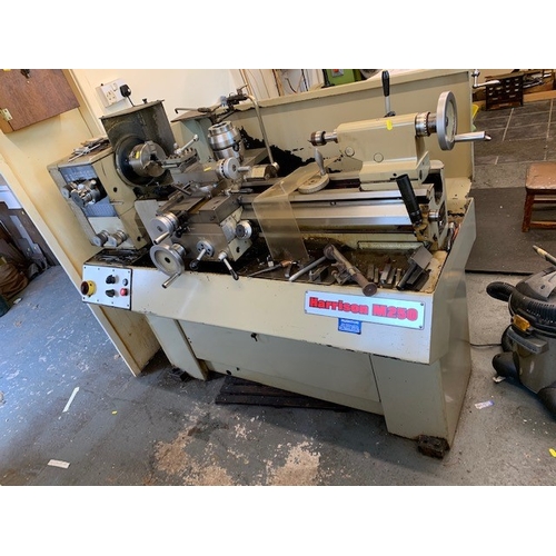 129 - A HARRISON M250 INDUSTRIAL LATHE, 150cm long and a stand containing chucks and other lathe accessori... 