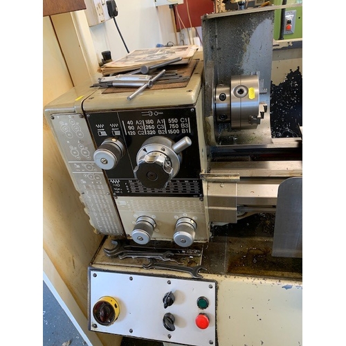 129 - A HARRISON M250 INDUSTRIAL LATHE, 150cm long and a stand containing chucks and other lathe accessori... 