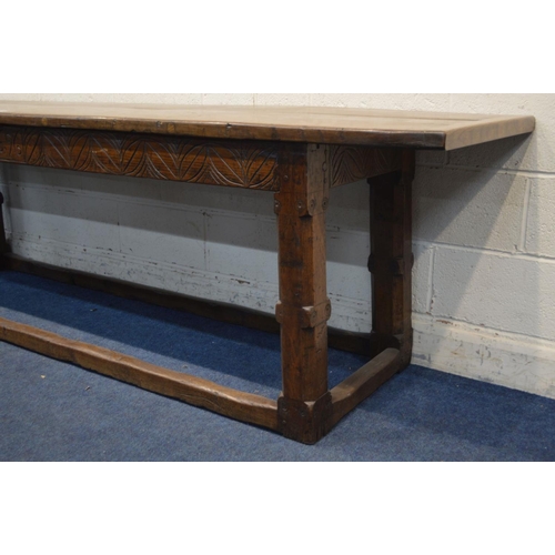 1206 - A 17TH CENTURY AND LATER OAK SERVING TABLE, double plank top, carved lunettes to frieze, on a jointe... 