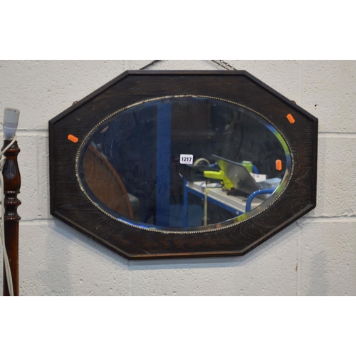 1217 - AN EARLY TWENTIETH CENTURY OAK FRAMED BEVELLED EDGE OAK MIRROR, together with two standard lamps and... 