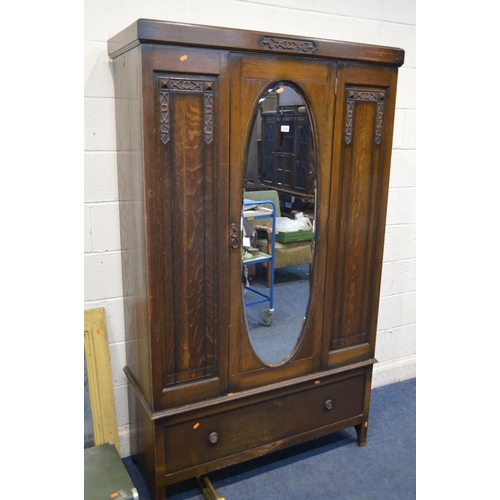 1223 - AN EARLY TO MID TWENTIETH CENTURY OAK SINGLE MIRROR DOOR WARDROBE, above a single drawer, a twentiet... 