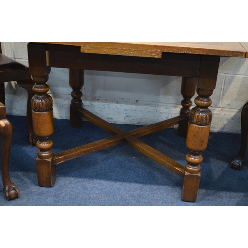 1224 - AN EARLY TO MID TWENTIETH CENTURY OAK DRAW LEAF TABLE, on acorn legs united by a cross stretcher, ex... 