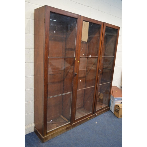 1230 - A LARGE DISTRESSED VICTORIAN MAHOGANY TRIPLE DOOR ASTRAGAL GLAZED BOOKCASE, with fourteen adjustable... 